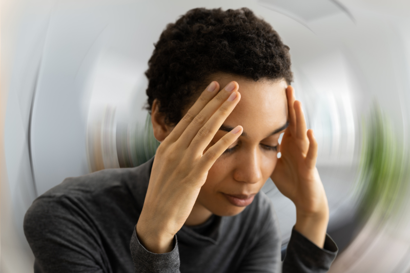 A woman experiencing vertigo and dizziness